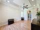An airy living room featuring wood floors, stylish wall trim, and an open archway to another area at 243 Bayou Bend Rd, Groveland, FL 34736