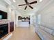 Bright living room with a fireplace, ceiling fan, and neutral palette at 243 Bayou Bend Rd, Groveland, FL 34736