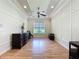Open living room with wood floors, large windows, and tasteful decor create an inviting space at 243 Bayou Bend Rd, Groveland, FL 34736