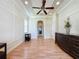 Spacious living area with wood flooring, modern trim and lighting, leading to an arched hallway at 243 Bayou Bend Rd, Groveland, FL 34736