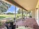 Screened patio with brick flooring, comfortable seating, and scenic backyard views at 243 Bayou Bend Rd, Groveland, FL 34736