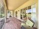 Screened patio with brick flooring, comfortable seating, and scenic backyard views at 243 Bayou Bend Rd, Groveland, FL 34736