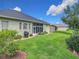 An expansive backyard with mature trees and an outdoor grill offers ample space for outdoor enjoyment and entertaining at 25222 Laurel Valley Rd, Leesburg, FL 34748