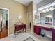 Bright bathroom featuring vanity with cabinets, an additional vanity space, and tile flooring at 25222 Laurel Valley Rd, Leesburg, FL 34748