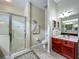Clean bathroom features glass shower enclosure, vanity with sink, and neutral tile flooring at 25222 Laurel Valley Rd, Leesburg, FL 34748