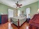 Charming bedroom with hardwood floors, ceiling fan, and windows providing natural light at 25222 Laurel Valley Rd, Leesburg, FL 34748