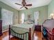 Charming bedroom with hardwood floors, ceiling fan, and windows providing natural light at 25222 Laurel Valley Rd, Leesburg, FL 34748