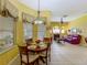 Open-concept dining area with a round table, decorative window coverings, and seamless access to living spaces at 25222 Laurel Valley Rd, Leesburg, FL 34748