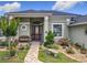 Charming home exterior with beautiful landscaping and a brick walkway to the front door at 25222 Laurel Valley Rd, Leesburg, FL 34748