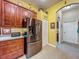 Well-equipped kitchen featuring stainless steel refrigerator, and tiled floors at 25222 Laurel Valley Rd, Leesburg, FL 34748