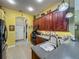 Bright, open kitchen with stainless appliances, wood cabinets, and tile floor at 25222 Laurel Valley Rd, Leesburg, FL 34748