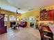Bright kitchen with wine rack, stainless steel fridge, and connection to the living room at 25222 Laurel Valley Rd, Leesburg, FL 34748