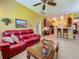 Inviting living room with open layout, connecting to the kitchen and dining area with tile floors at 25222 Laurel Valley Rd, Leesburg, FL 34748