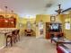 Open-concept living room adjacent to the kitchen and dining area featuring neutral tile flooring at 25222 Laurel Valley Rd, Leesburg, FL 34748