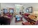 Spacious living room with plush seating, tile flooring, and lots of natural light at 25222 Laurel Valley Rd, Leesburg, FL 34748