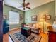 Comfortable living room featuring a ceiling fan, a sitting area rug, and a window at 25222 Laurel Valley Rd, Leesburg, FL 34748
