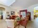 Open concept living room features tiled floors, comfortable seating and a view to dining area at 25222 Laurel Valley Rd, Leesburg, FL 34748