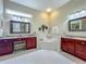 Bright main bathroom featuring dual vanities and a large soaking tub at 25222 Laurel Valley Rd, Leesburg, FL 34748