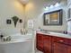 Bright main bathroom featuring dual vanities and a large soaking tub at 25222 Laurel Valley Rd, Leesburg, FL 34748