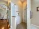 Shower with safety bar view to main bedroom with hardwood floors and ceiling fan at 25222 Laurel Valley Rd, Leesburg, FL 34748