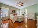 Spacious main bedroom with hardwood floors, a ceiling fan, and ensuite bathroom access at 25222 Laurel Valley Rd, Leesburg, FL 34748
