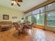 Bright sunroom with tile flooring, large windows, and a dining set for entertaining at 25222 Laurel Valley Rd, Leesburg, FL 34748