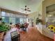 Inviting sunroom boasts a tile floor, ceiling fan, and an abundance of natural light creating a peaceful ambiance at 25222 Laurel Valley Rd, Leesburg, FL 34748