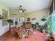 Bright sunroom with tile flooring, large windows, and a dining set for entertaining at 25222 Laurel Valley Rd, Leesburg, FL 34748