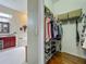 Walk-in closet with wire shelving adjacent to a bright bathroom at 25222 Laurel Valley Rd, Leesburg, FL 34748