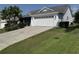 Exterior of the property showcasing a paved driveway with a star design and well-maintained landscaping at 2530 Hanlon Ter, The Villages, FL 32162