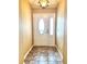 Inviting foyer with tiled flooring, a decorative front door, and neutral wall colors at 2530 Hanlon Ter, The Villages, FL 32162