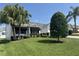 Charming single-story home with lush landscaping, mature trees, and black awnings at 2530 Hanlon Ter, The Villages, FL 32162