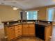 Functional kitchen with eat in bar area, stainless steel sink, and modern appliances at 2530 Hanlon Ter, The Villages, FL 32162