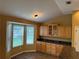 Bright kitchen nook features a bay window, custom cabinets and stone countertops at 2530 Hanlon Ter, The Villages, FL 32162