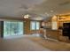 Open living space combining the living room, kitchen, and dining area, with sliding doors to the lanai at 2530 Hanlon Ter, The Villages, FL 32162