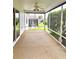 Enclosed screened porch with fan offering an extension of outdoor living space at 2530 Hanlon Ter, The Villages, FL 32162