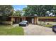 Single-story home with stone accents and a long driveway at 2707 Woodbridge Ln, Orlando, FL 32808