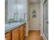 Bathroom featuring a single sink vanity, mirror, white towels, and a glass shower door at 2799 Privada Dr, The Villages, FL 32162
