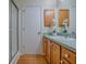 Bathroom vanity with blue countertop, wood cabinets, sink, and glass shower enclosure at 2799 Privada Dr, The Villages, FL 32162