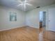 Spacious bedroom featuring wood floors, neutral walls, and ensuite bathroom access at 2799 Privada Dr, The Villages, FL 32162
