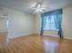 A spacious bedroom with a fan, wood floors, and a decorative window treatment at 2799 Privada Dr, The Villages, FL 32162