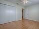 A bright bedroom with laminate flooring, a ceiling fan, and a spacious closet at 2799 Privada Dr, The Villages, FL 32162