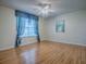 Bright bedroom with hardwood floors, ceiling fan and decorative window curtain at 2799 Privada Dr, The Villages, FL 32162