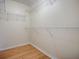 Walk-in closet with white wire shelving and wood flooring at 2799 Privada Dr, The Villages, FL 32162