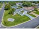 Exterior shot featuring lush front yard, palm trees, and beautifully maintained home at 2799 Privada Dr, The Villages, FL 32162