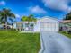 Lovely home with pristine lawn and landscaping, complemented by a clean and recently updated exterior at 2799 Privada Dr, The Villages, FL 32162