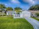 Charming single-story home with a lush green lawn and well-maintained landscaping at 2799 Privada Dr, The Villages, FL 32162