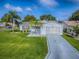 Charming single-story home with a lush green lawn and well-maintained landscaping at 2799 Privada Dr, The Villages, FL 32162