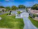 Charming single-story home with a lush green lawn and well-maintained landscaping at 2799 Privada Dr, The Villages, FL 32162