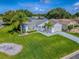 Charming single-story home with a lush green lawn and well-maintained landscaping at 2799 Privada Dr, The Villages, FL 32162